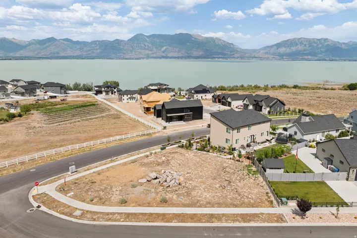 Expansive corner lot featuring a paved street and sidewalk infrastructure
