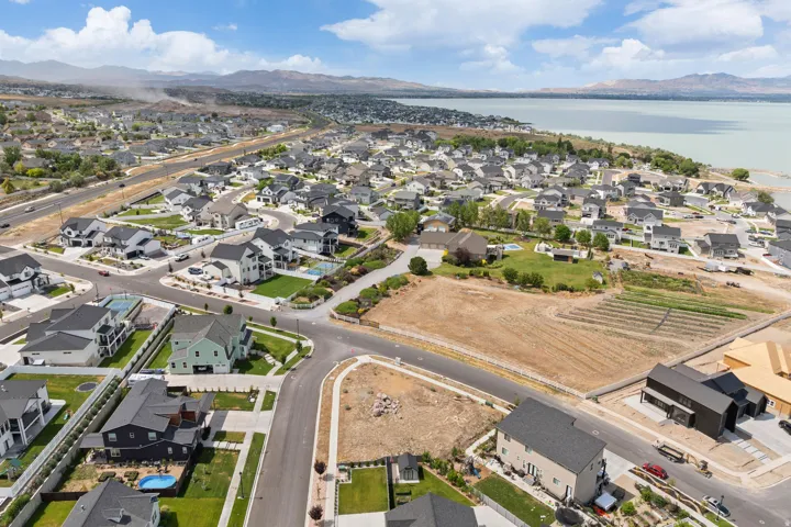 Aerial perspective showcasing a residential development with a prominent body of water in the background