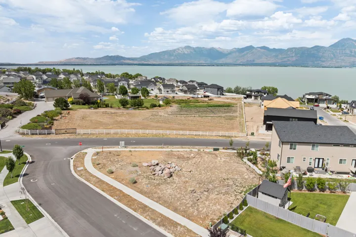 Expansive vacant land parcels featuring curb-cut access and surrounding residential development