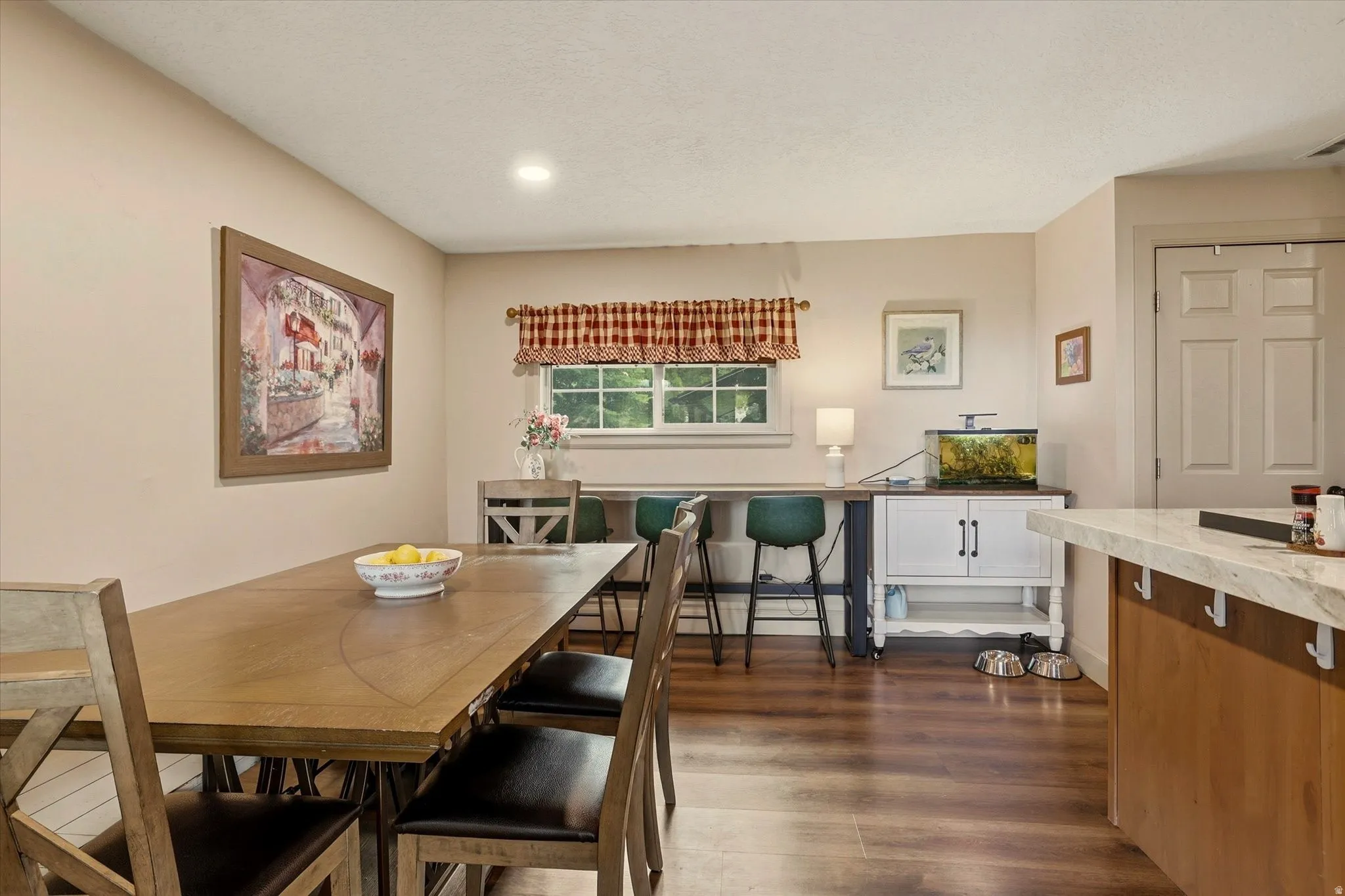 Dining area featuring wood-finish flooring, recessed lighting, and a window with exterior visibility