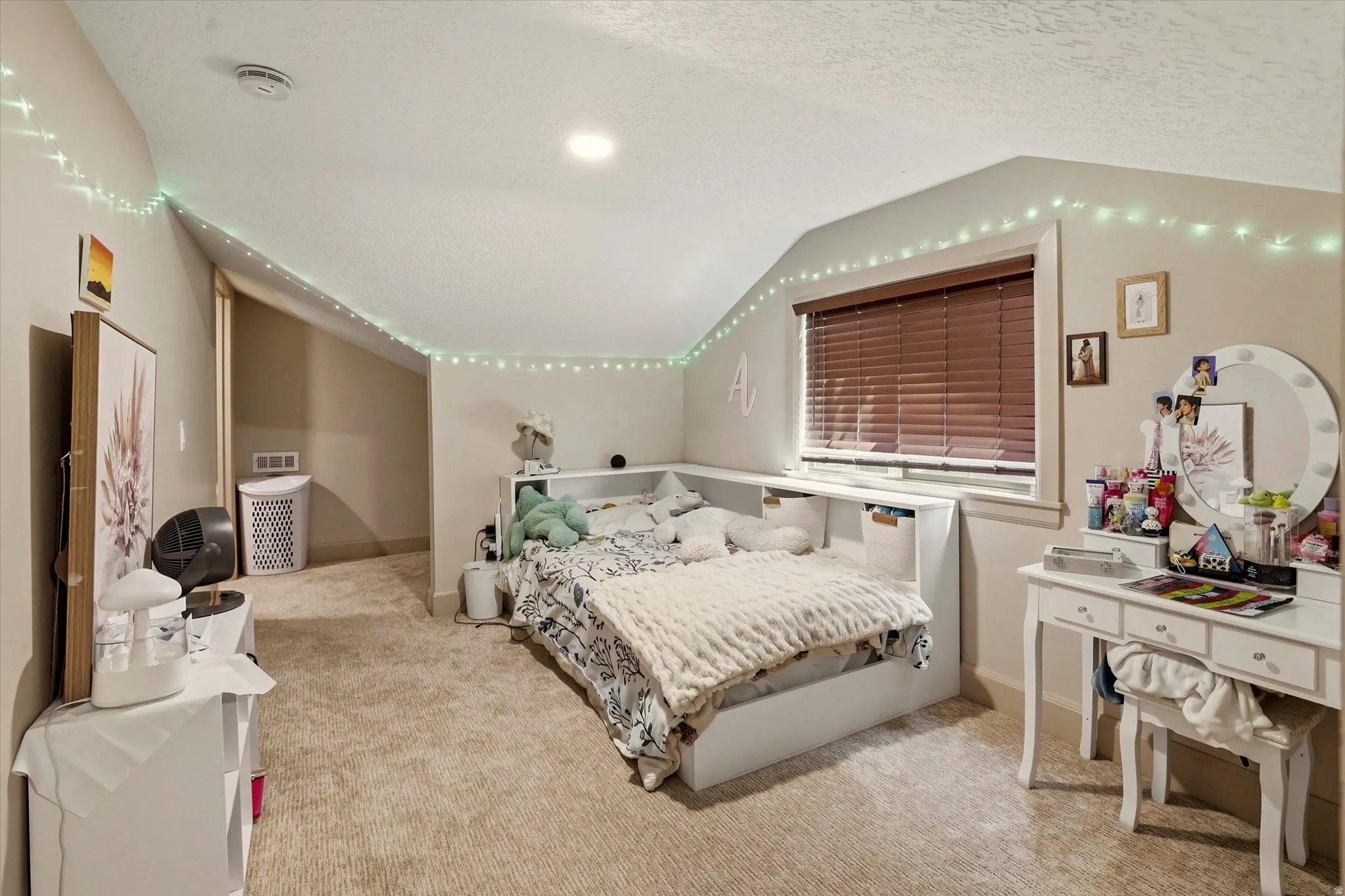 Carpeted room featuring a window with blinds, recessed lighting, and a built-in storage bench
