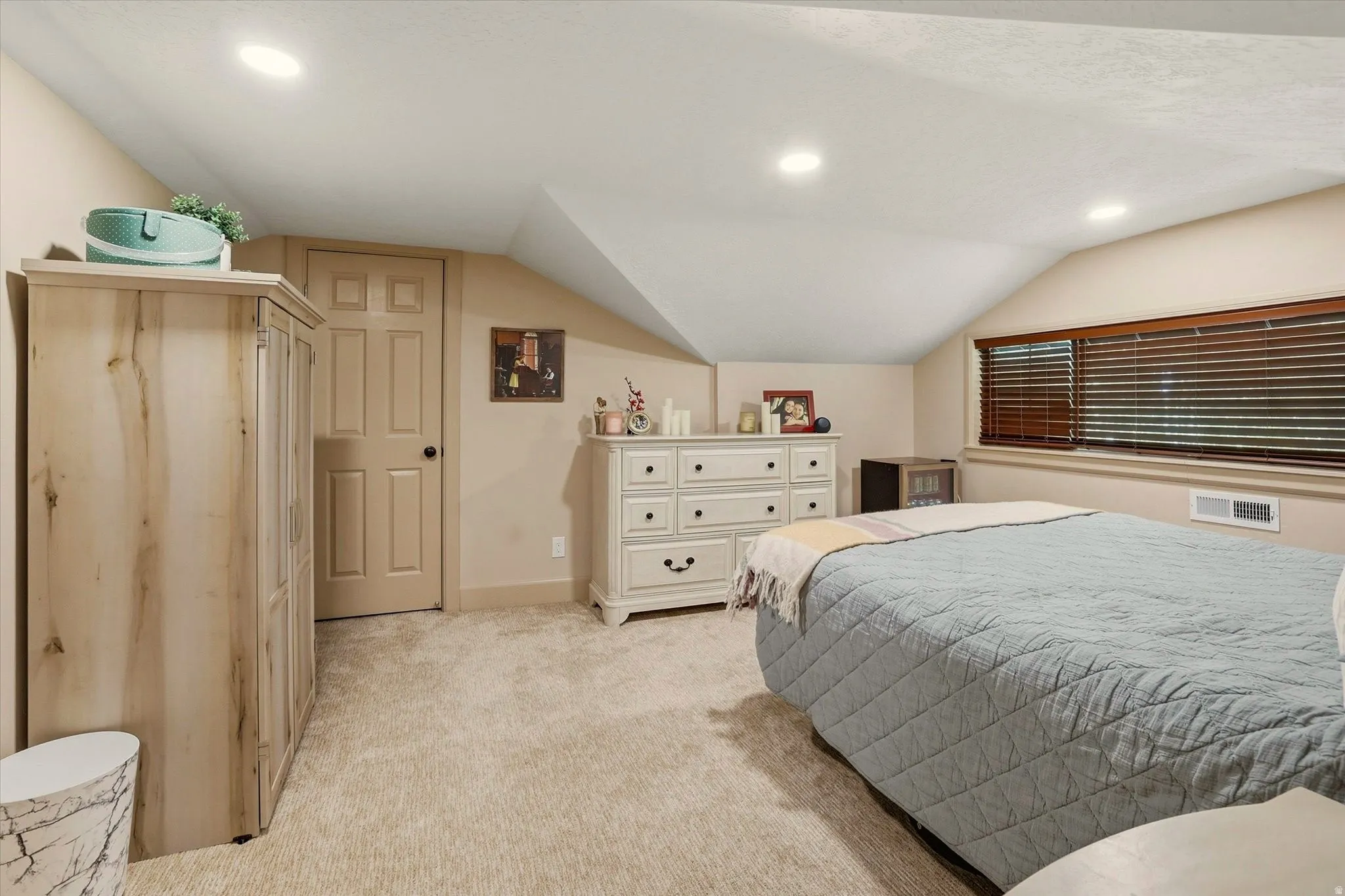 Carpeted room featuring recessed lighting, a window with wood-finish blinds, and a paneled door
