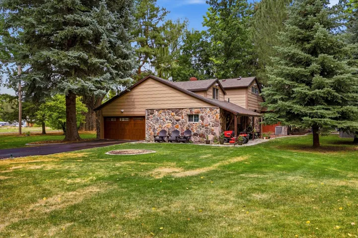 Exterior featuring a combination of stone veneer and wood siding