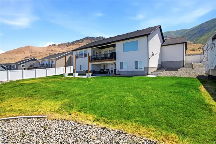 Expansive rear yard featuring a verdant lawn and a full vinyl privacy fence