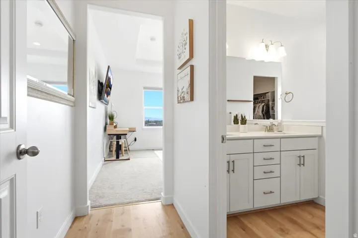 Bright interior hallway with light wood-finish flooring