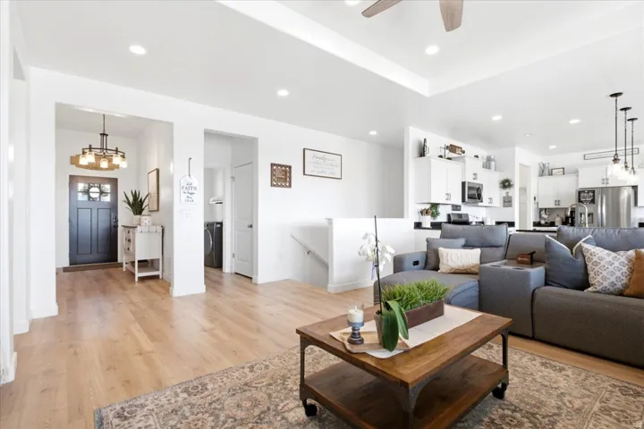 Open concept living area featuring light wood-finish flooring, recessed lighting, and a neutral color palette