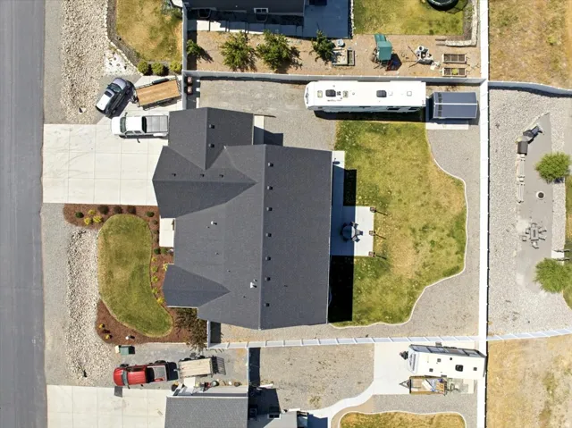 Aerial perspective of a property featuring a multi-gabled roofline and a concrete driveway