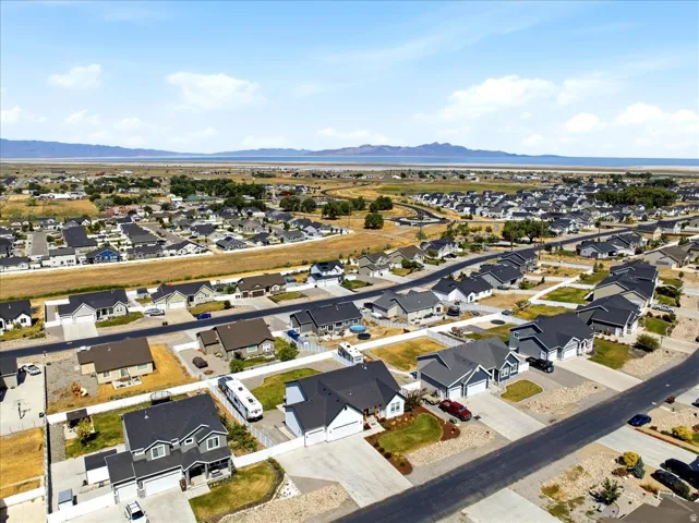 Expansive residential development featuring numerous single-family homes, wide paved streets, and structured landscaping
