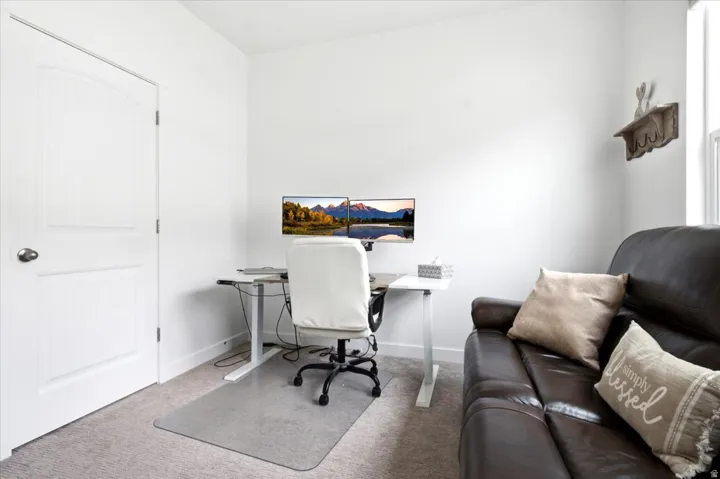 Bright interior space featuring white walls and a paneled door with an arched top detail