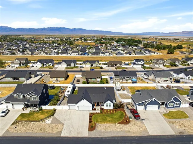 Expansive residential development featuring a variety of architectural styles, individual paved driveways, and landscaped front yards