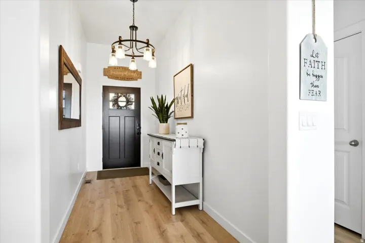 Entryway featuring wood-finish flooring and white walls
