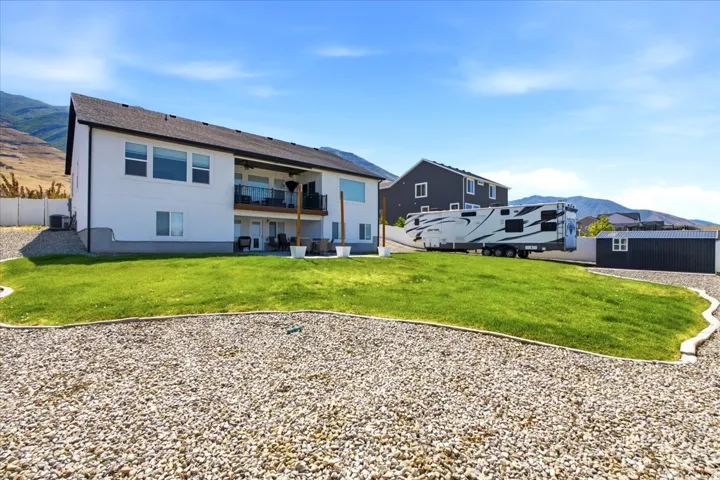 Expansive rear yard featuring a manicured lawn and gravel landscaping