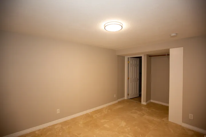 Bedroom with ensuite neutral-toned walls and travertine flooring define this interior space