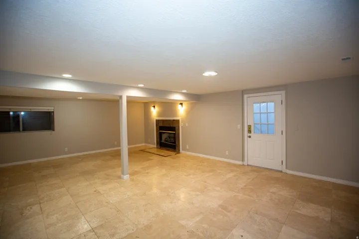 Spacious room featuring neutral painted walls and large format tile flooring