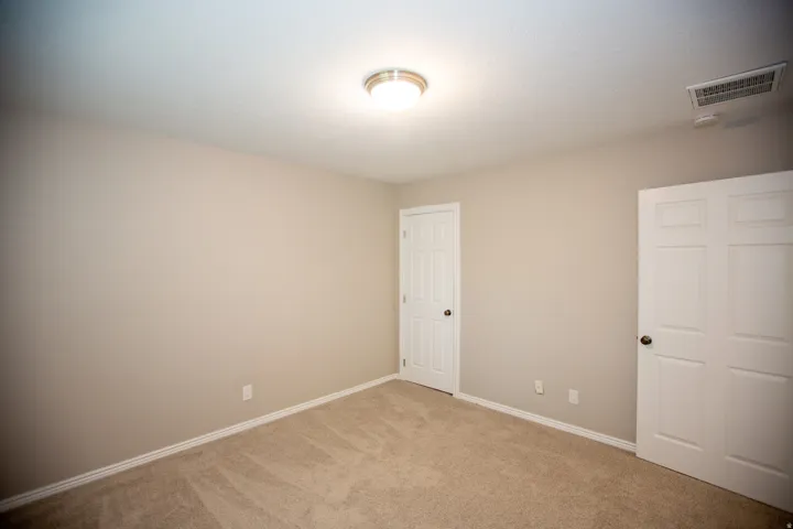 Neutral-toned interior with light tan carpeting and matching wall paint