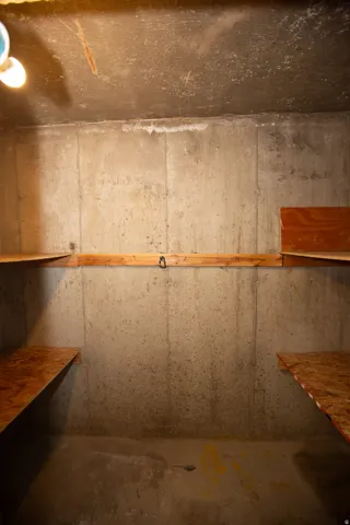 Cold storage area featuring exposed concrete walls and ceiling