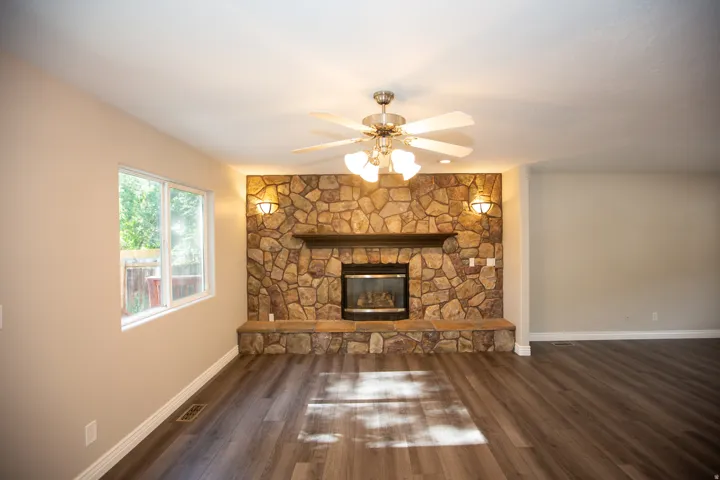 Stone fireplace with a dark wood mantel and glass-front insert