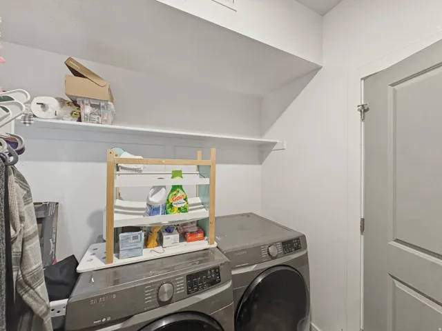 Dedicated laundry area featuring white shelving
