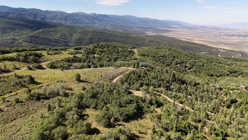 Expansive natural landscape featuring rolling hills and distant mountains