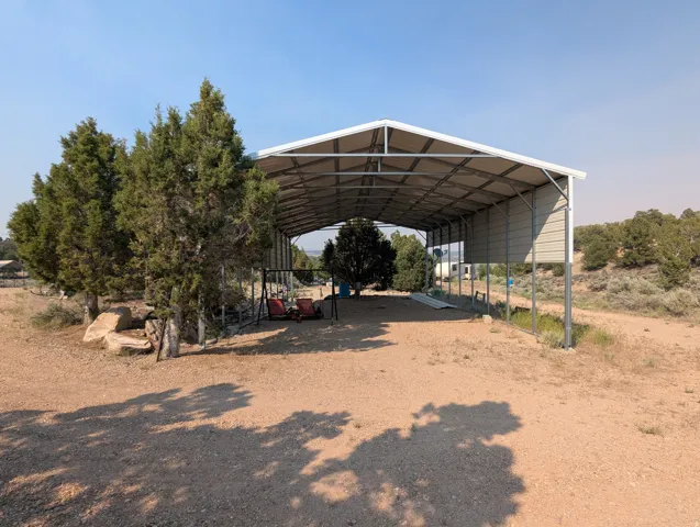 Expansive metal carport structure featuring a durable frame and corrugated roof