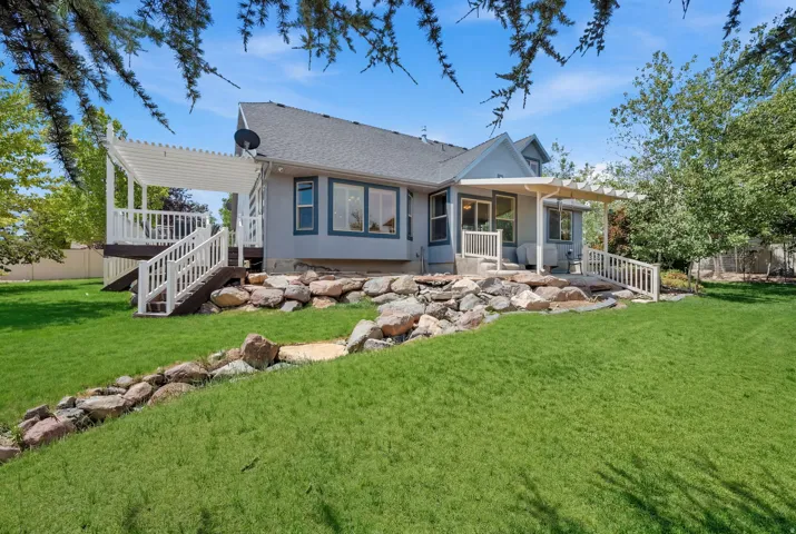 Expansive green lawn bordering a rock-lined landscape feature