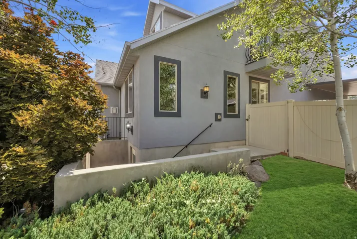 Stucco exterior with dark trim windows
