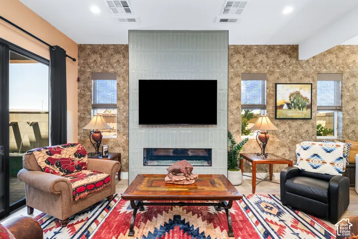 Living area featuring a floor-to-ceiling tile fireplace surround with an integrated linear firebox