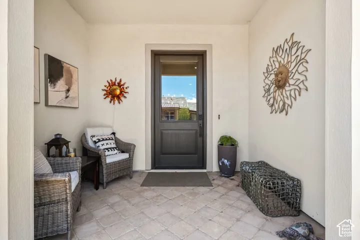 Recessed entry with light-toned stucco walls and a paneled entry door