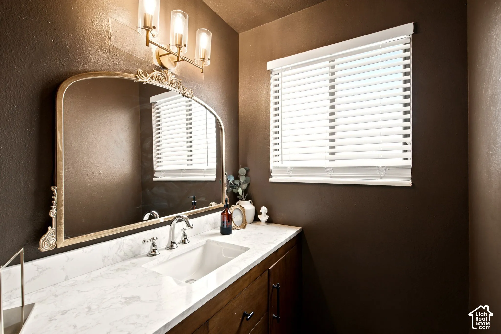 Vanity with a white countertop and integrated rectangular sink