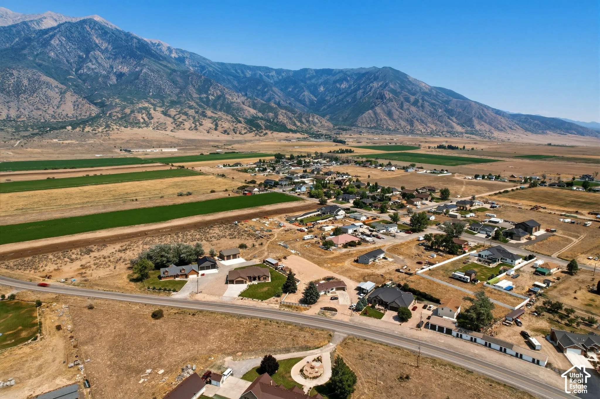 Expansive aerial capturing a community with a prominent mountain backdrop