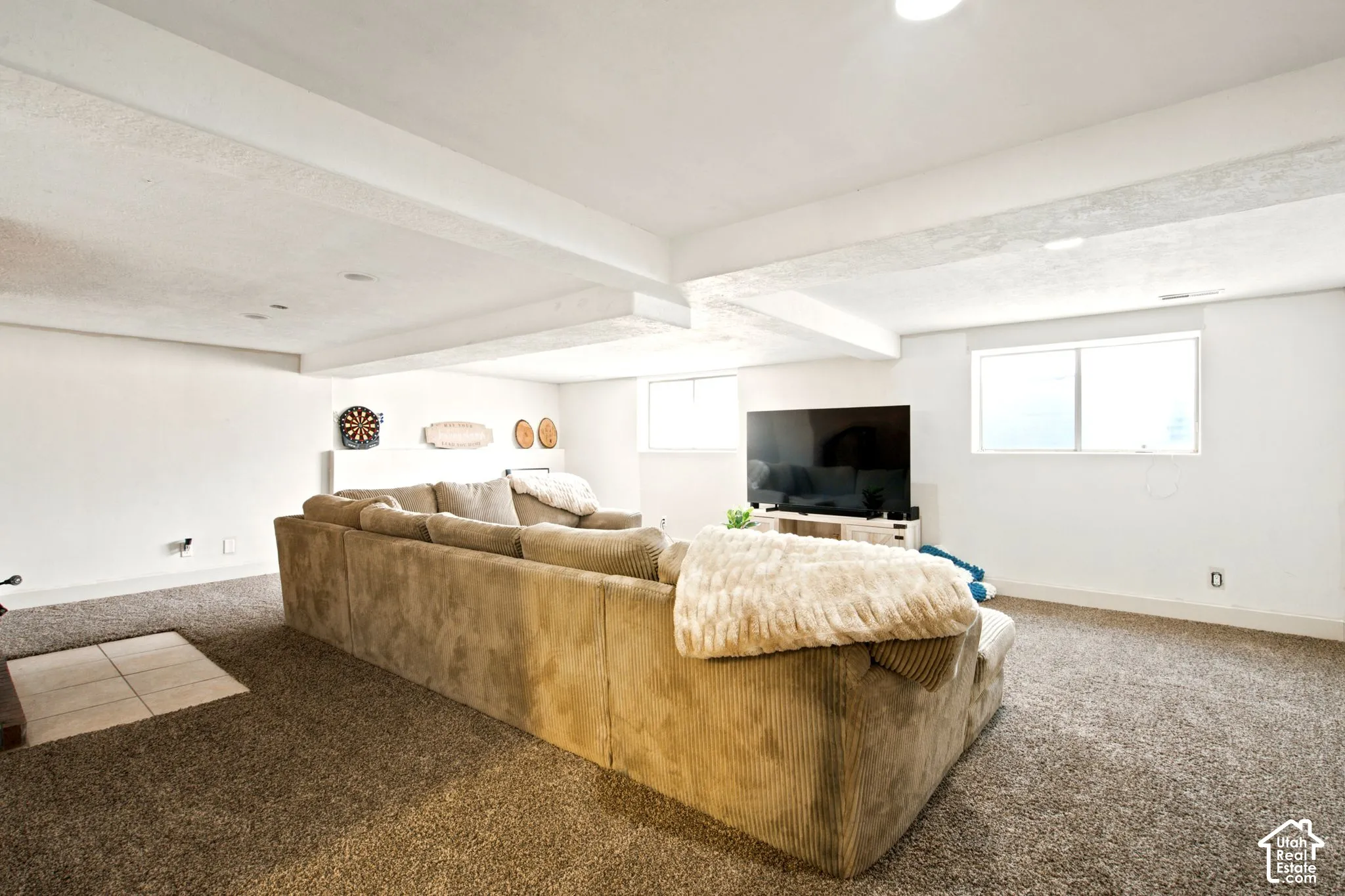 Spacious room featuring neutral carpeting and white painted walls