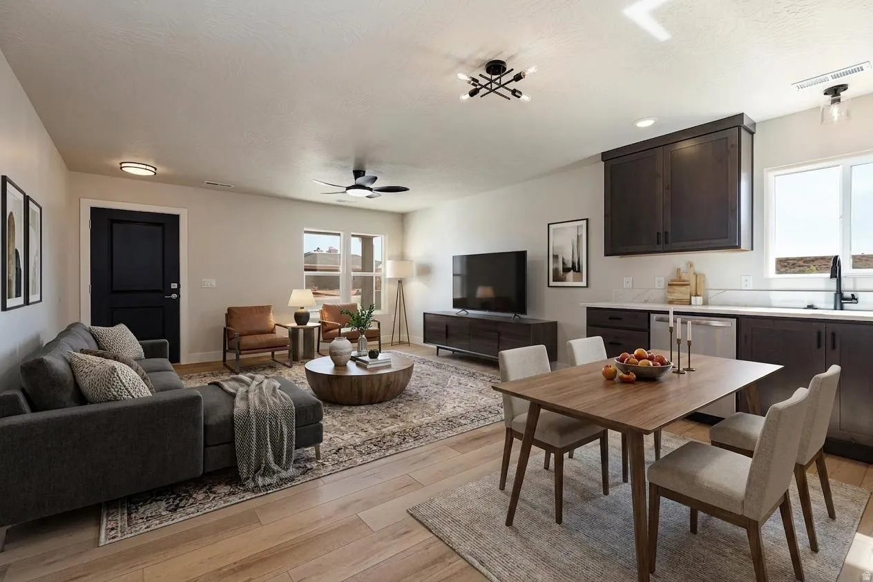 Digitally Staged-Open-concept living area featuring wood-finish flooring, a contemporary ceiling fan, and multiple windows providing natural illumination