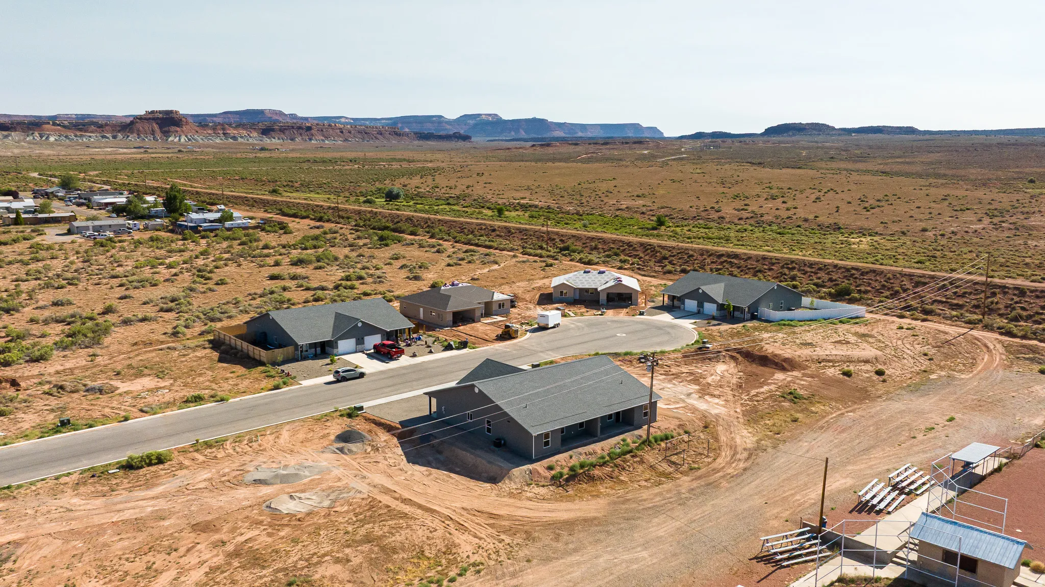 New construction residences featuring varied architectural styles and gray shingle roofs