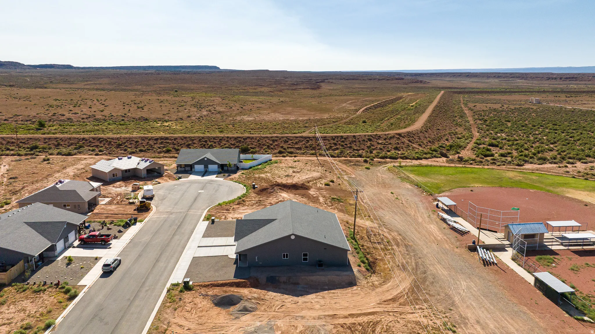 Aerial perspective showcasing a developing residential area with paved streets and cul-de-sac