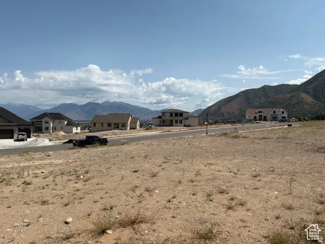 Expansive undeveloped lot featuring mountain scenery and paved street access