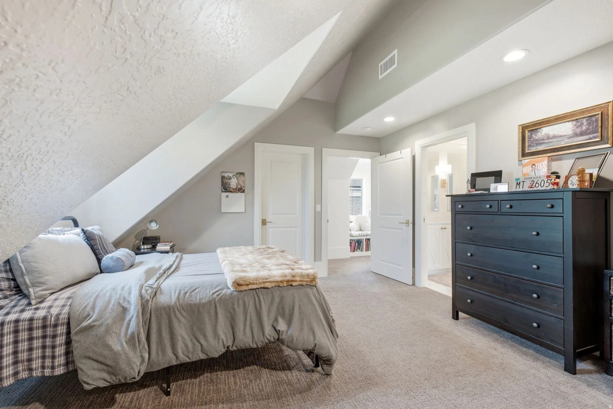 Carpeted room featuring a sloped ceiling, recessed lighting, white trim, and a doorway to an additional space