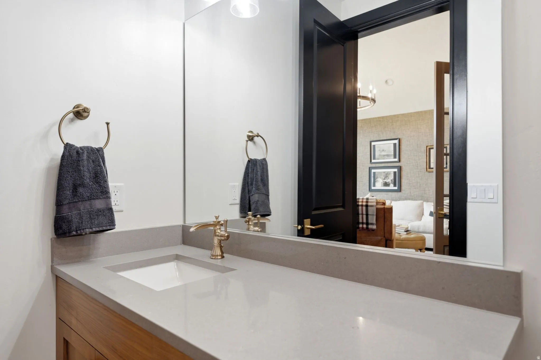 Bathroom vanity featuring a light gray countertop with an integrated rectangular sink