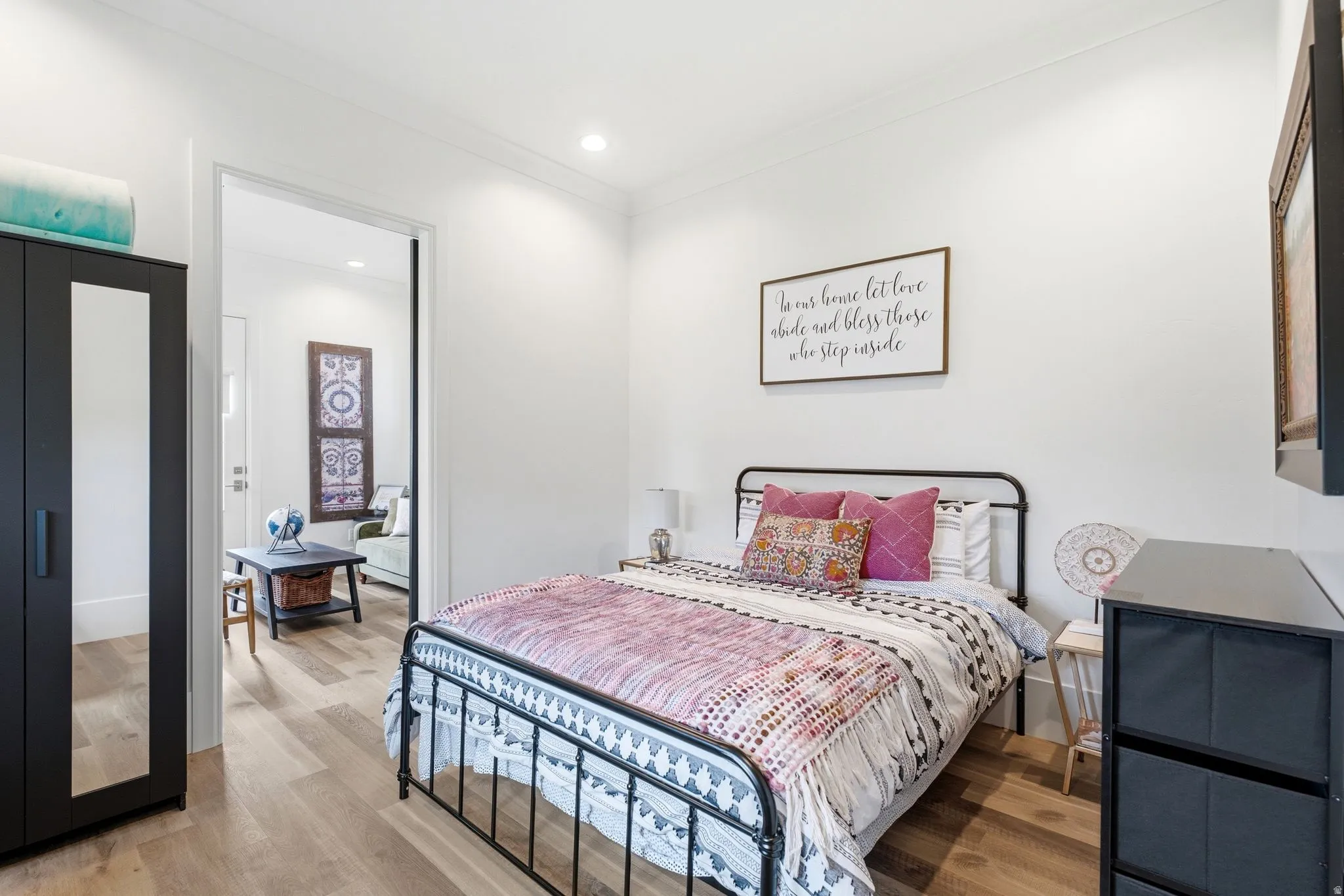Bright room featuring wood-finish flooring, white walls, and recessed lighting