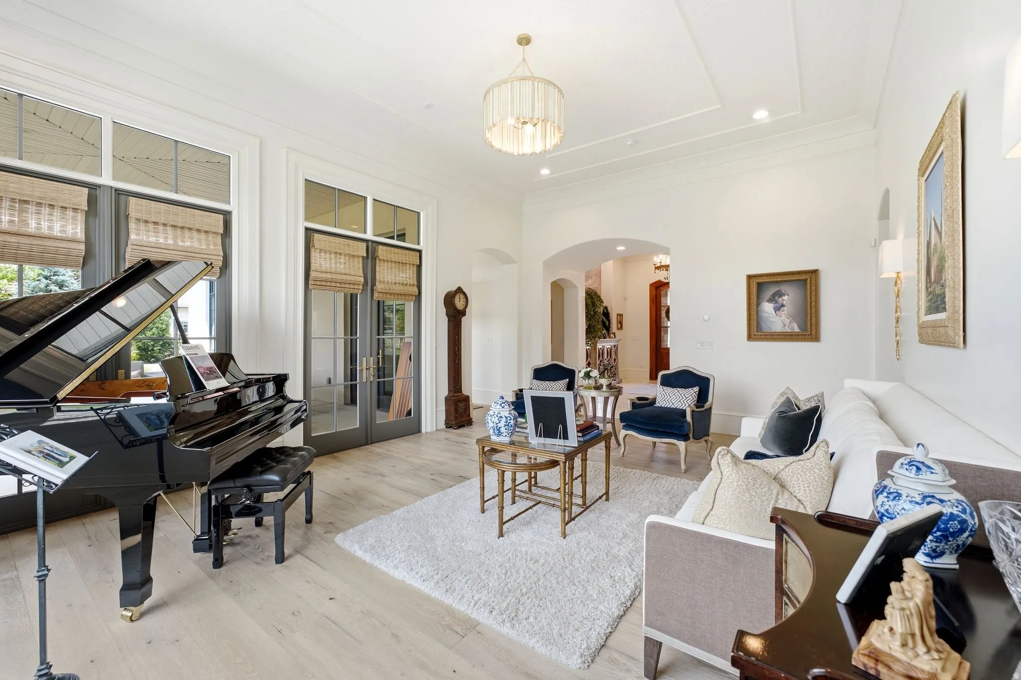 Spacious room featuring light wood-finish flooring and a white area rug
