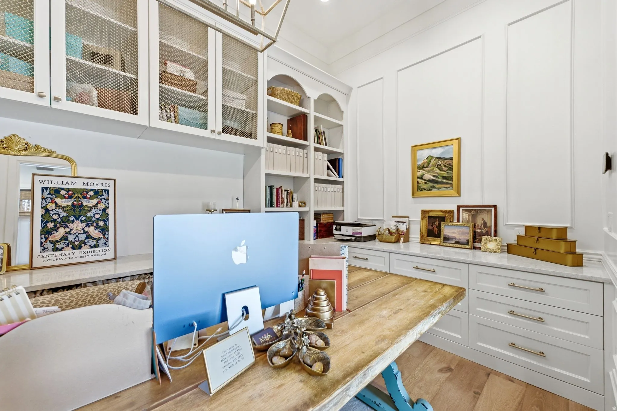 Custom built-in cabinetry with mesh-front uppers, integrated shelving, and a stone countertop