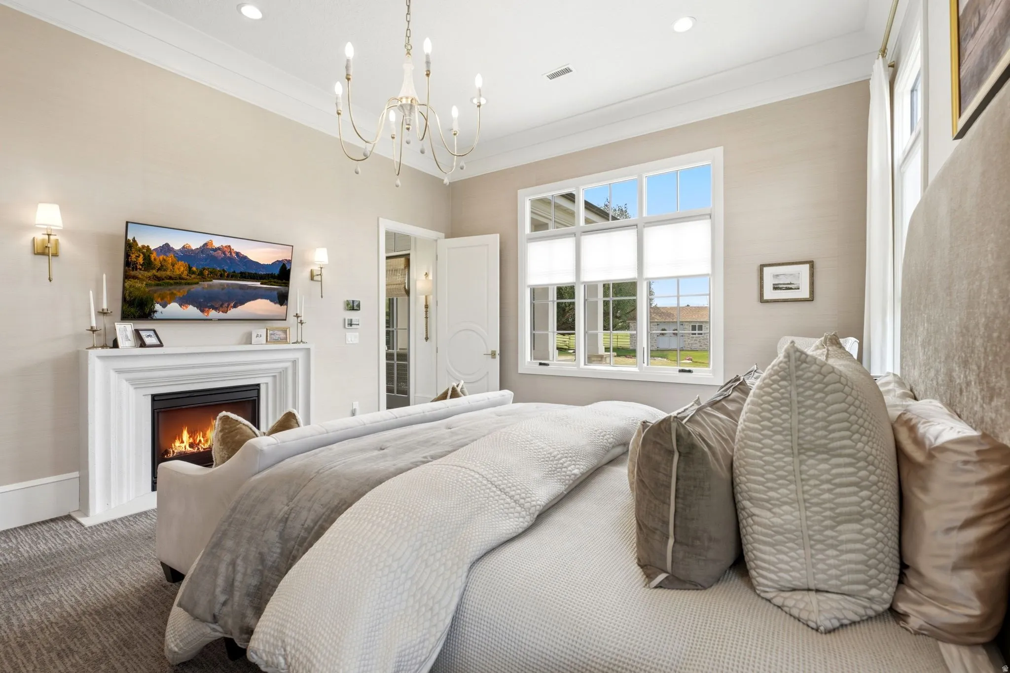Bedroom featuring a classic white fireplace with a mantle, a multi-pane window, and recessed lighting