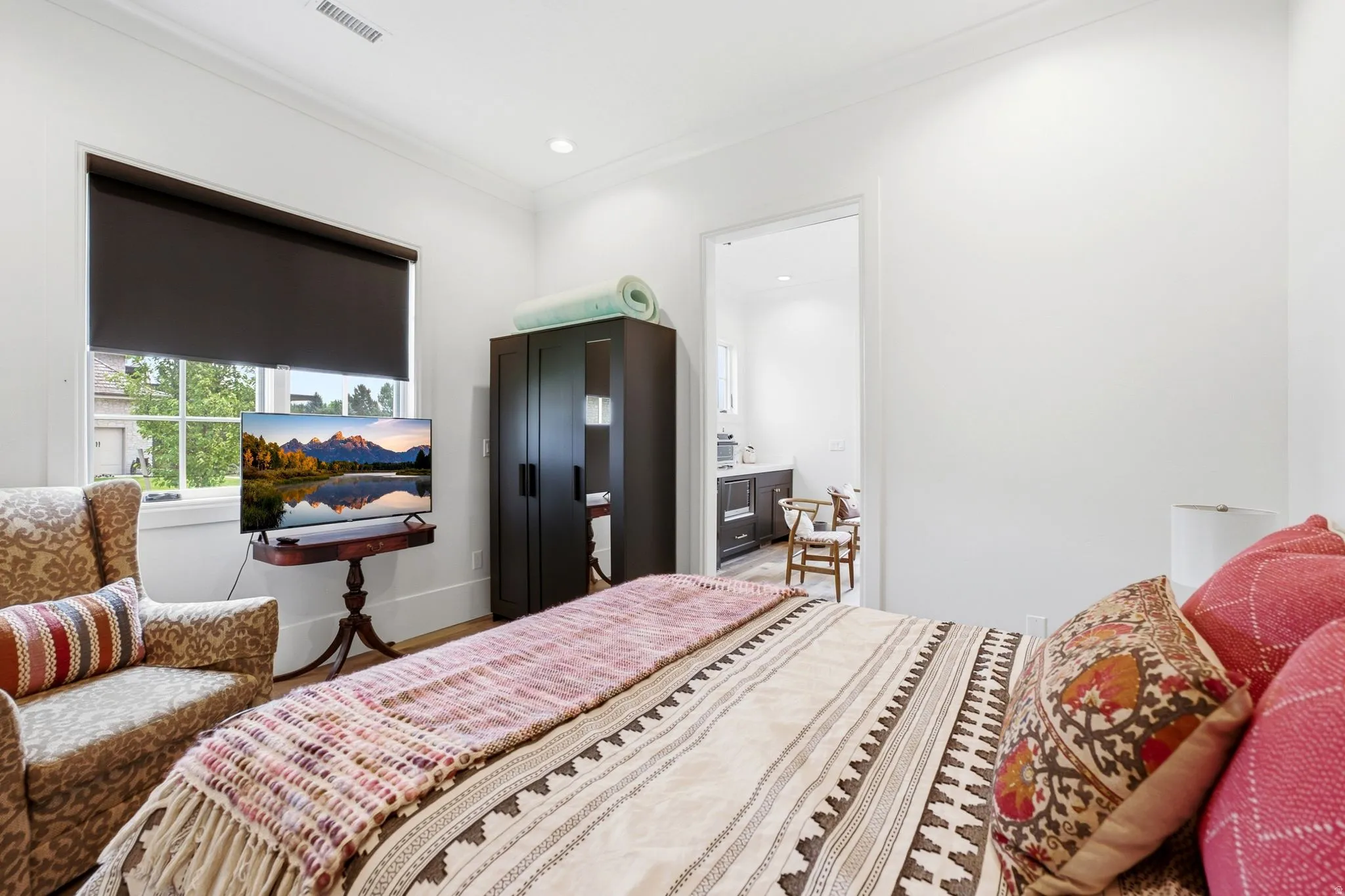 Bedroom featuring white walls, crown molding, recessed lighting, and wood-finish flooring