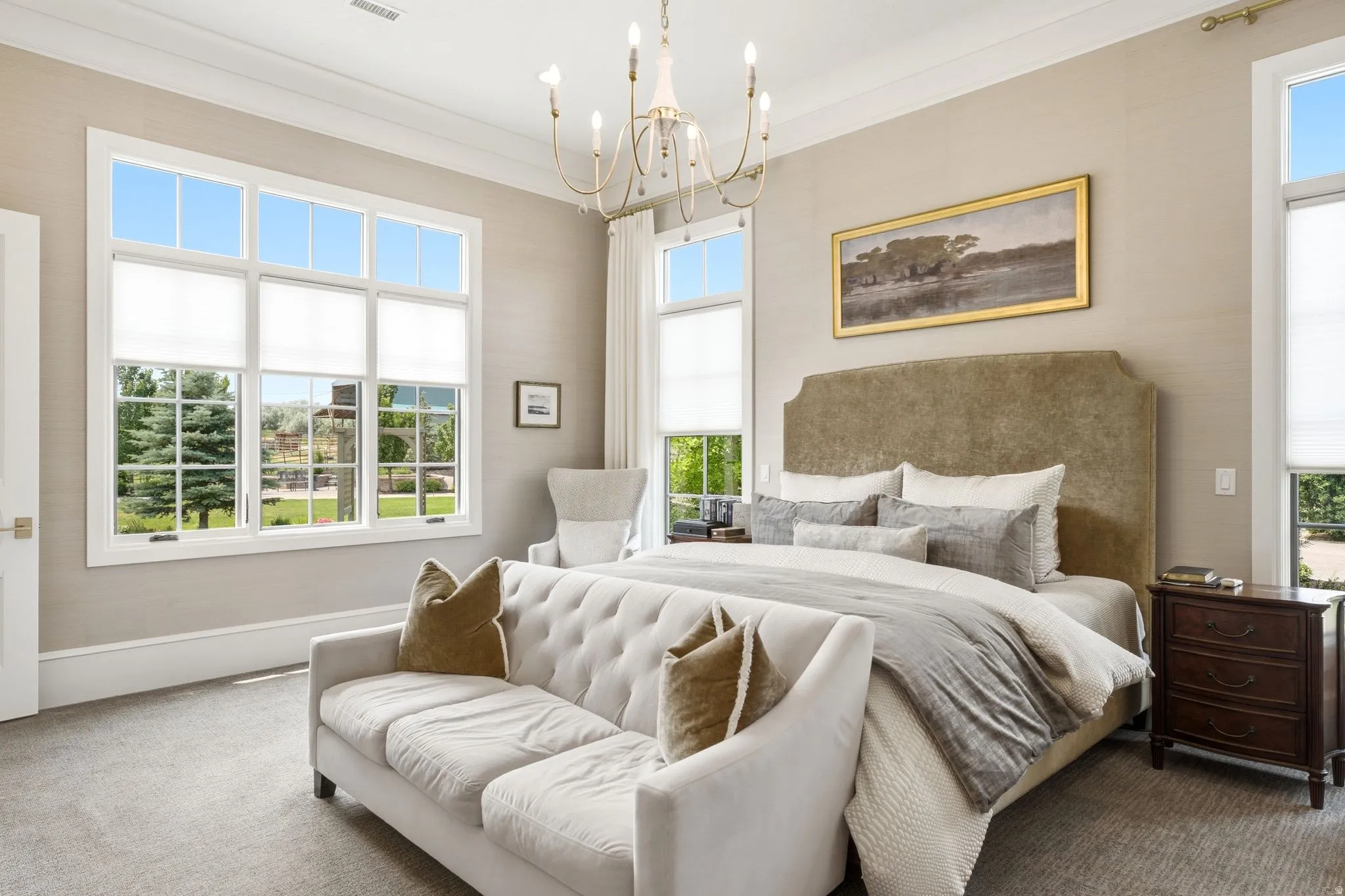Expansive room featuring multiple large windows with white trim, textured wall coverings, and crown molding
