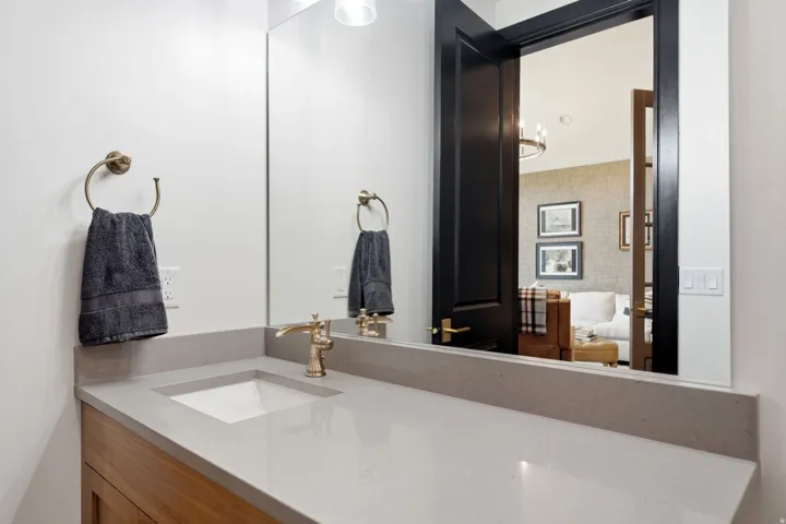 Bathroom vanity featuring a light gray countertop with an integrated rectangular sink