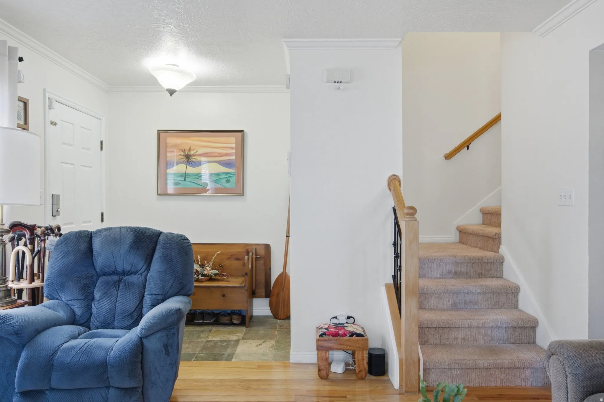 Carpeted staircase with wood banister and wrought iron spindles