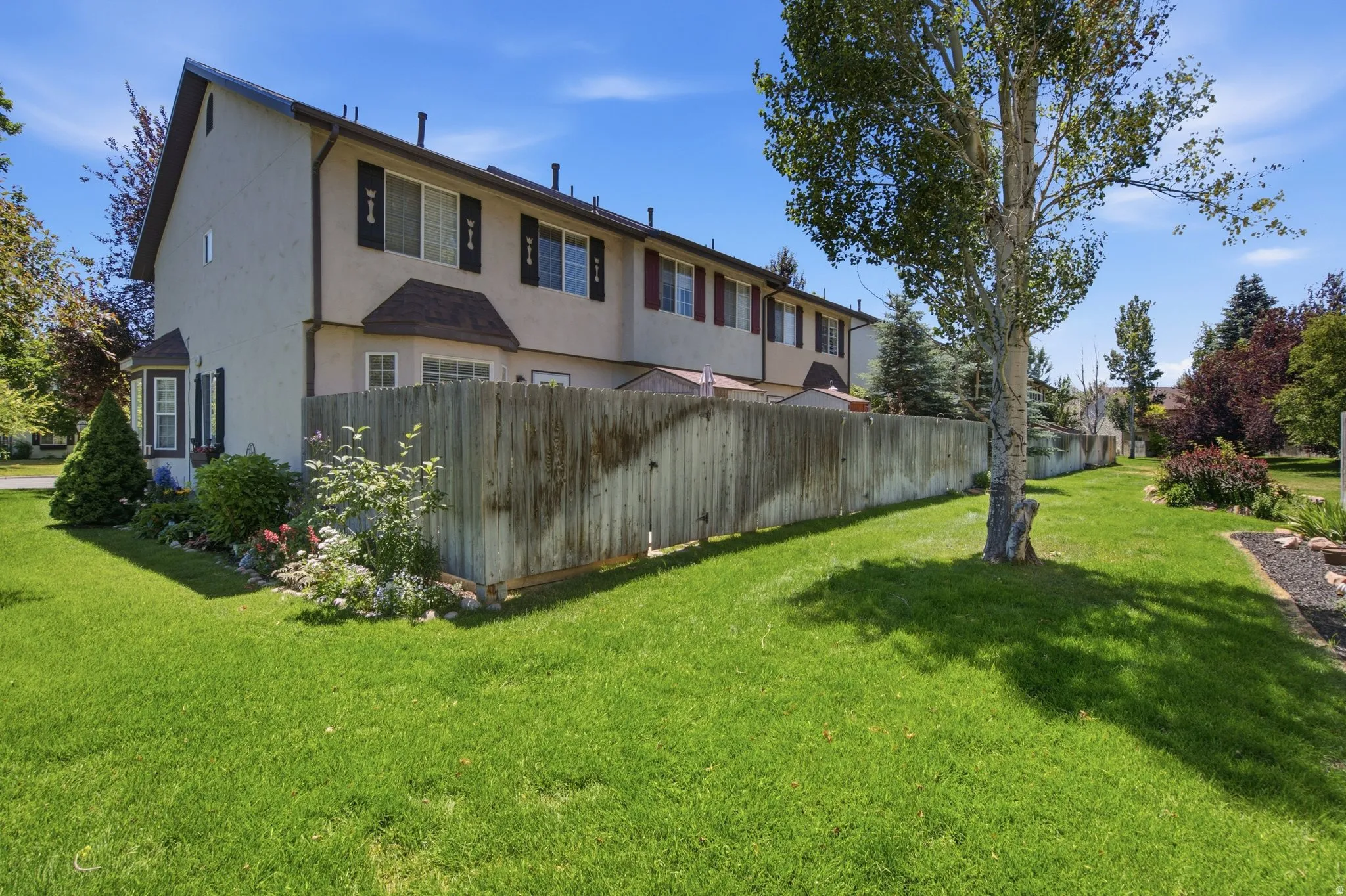 Manicured lawn area with a mature tree