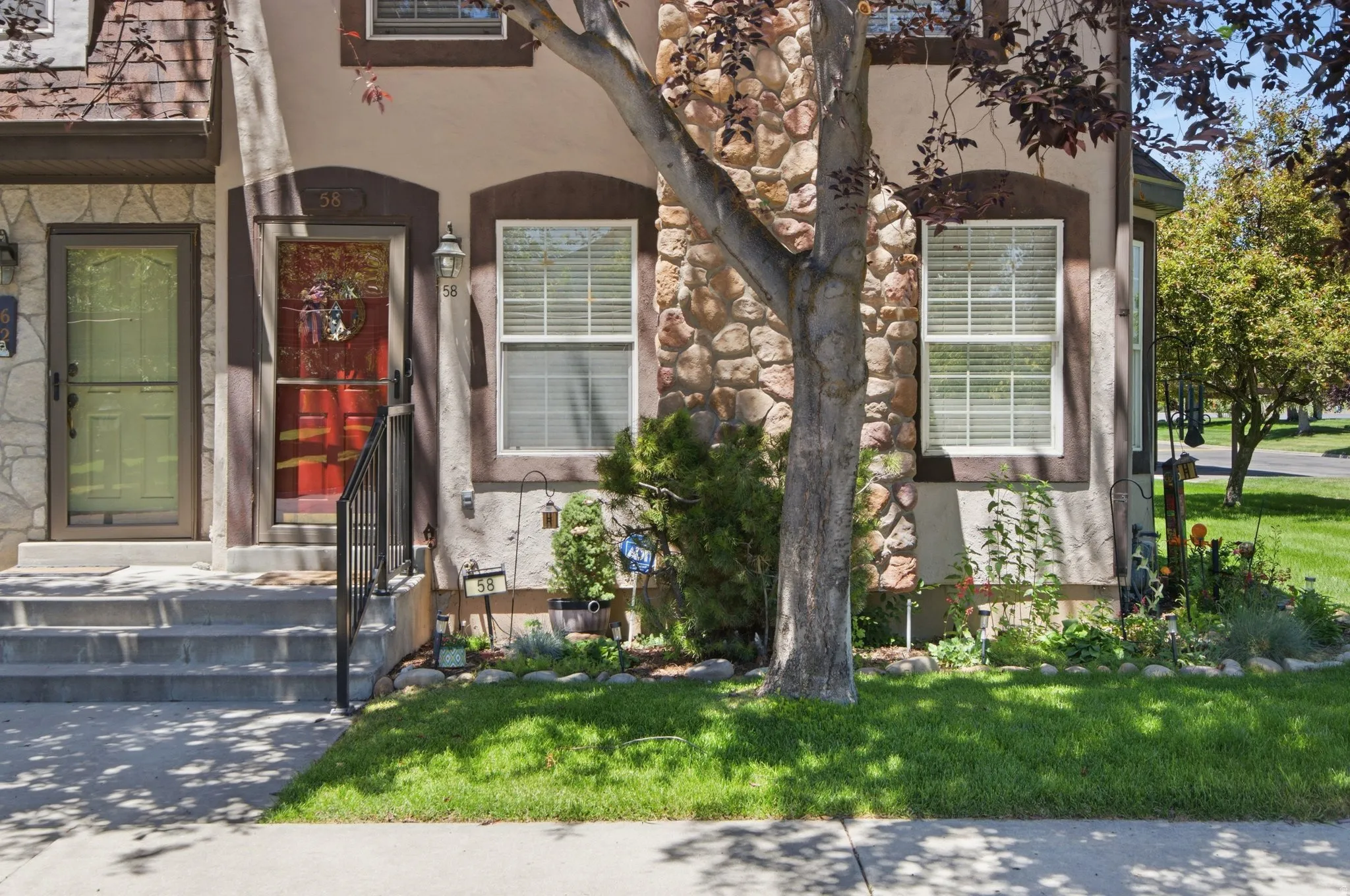 Exterior featuring a stone and stucco facade with dark trim accents