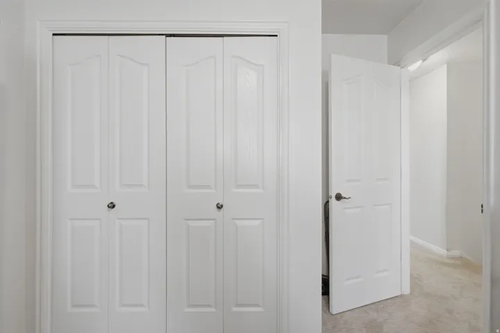 White paneled bi-fold doors with round knobs