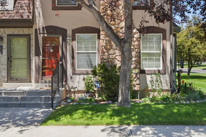 Exterior featuring a stone and stucco facade with dark trim accents