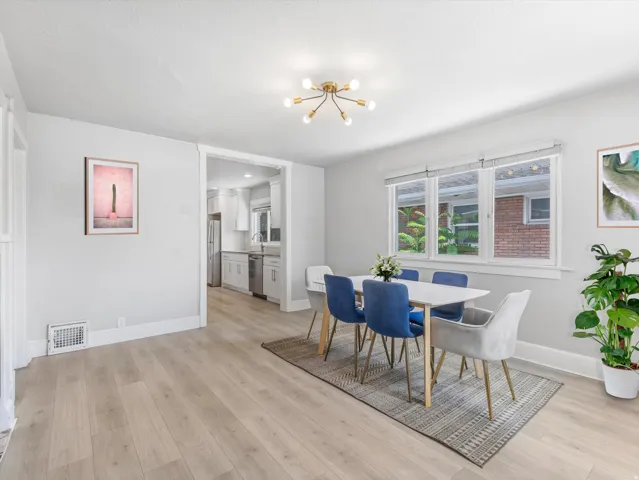 Light wood-finish flooring extending into the kitchen
